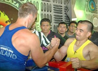 Champion arm wrestlers Arturs Dorohoff (left), winner of two categories, and Suttiwas Kohsamut (right), winner of the under 75kg event, face off in an exhibition bout during the 10th Pattaya International Arm Wrestling Championships held at the Royal Garden Plaza last weekend. 80 strong men from around the world competed for cash and trophies so big, only the strongest arms could carry them home.