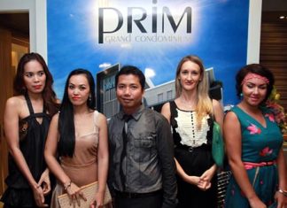 Porchland Group CEO, Chisanucha Phakdeesaneha (center), poses with guests at the launch of the Prim Grand Condominium on Oct. 8.