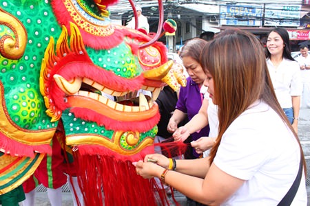 Feeding the dragon by putting cash in the dragon’s mouth will hopefully bring prosperity.  Either way, the funds are donated to the needy.