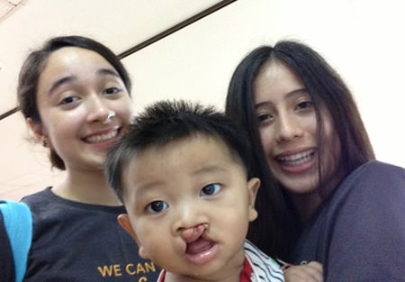 Students help to entertain children before their surgery.