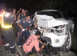 Rescue officials use Jaws of Life to extract one of the victims from the wreck.