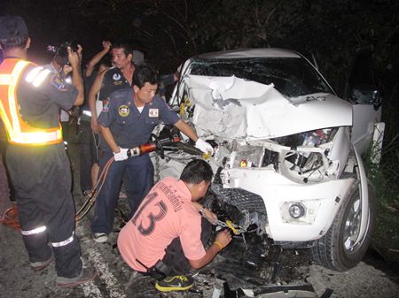 Rescue officials use Jaws of Life to extract one of the victims from the wreck.