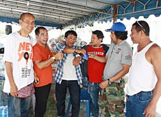 He just wanted to help - Jakrit Mukpradap (center) was arrested for drug possession when trying to donate ya ba to the flood relief effort.