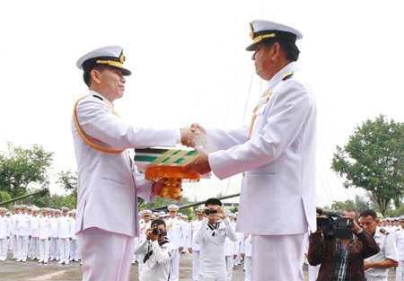 ACDC chief Rear Adm. Noppadol Suphakorn hands over administrative documents to Rear Adm. Luechai Ruddit, bestowing command of the Air and Coastal Defense Command in Sattahip.