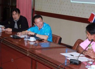 Deputy Mayor Ronakit Ekasingh (left) and Banglamung District Chief Sakchai Taengho meet with city officials to hash out details of a new system, which designates legally operated motorbike taxis with yellow license plates.