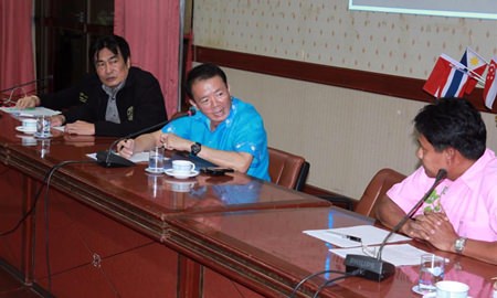 Deputy Mayor Ronakit Ekasingh (left) and Banglamung District Chief Sakchai Taengho meet with city officials to hash out details of a new system, which designates legally operated motorbike taxis with yellow license plates.