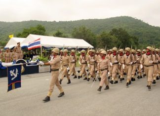 Cadets who graduated from the Naval Recruit Training Center in Bang Saray, taking up service as Royal Thai Marines, march past their commanding officer.