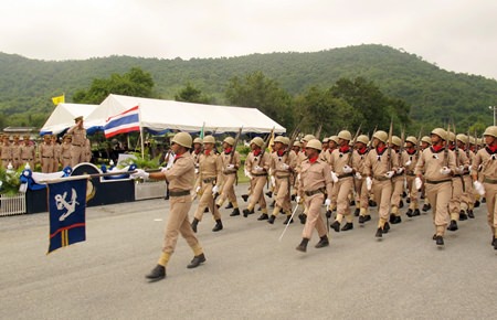 Cadets who graduated from the Naval Recruit Training Center in Bang Saray, taking up service as Royal Thai Marines, march past their commanding officer.
