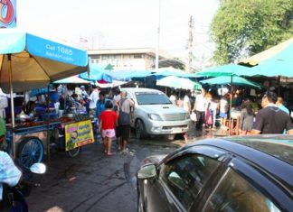 Vendors have set up their wares on the sidewalks leading to the parking lot in the Lan Po Market area.