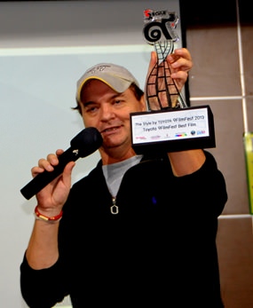 Steven Rouse holds the first-place trophy his film production company won recently at the Toyota 9FilmFest 2013 in Bangkok, beating out over 200 entries (they also won a Toyota car). Steven will be the PCEC guest speaker on November 3. He will present the 9 minute video and talk about making this prize winning film “The Guardian,” which is about a man that lives by the river and knows he is old but teaches himself to swim.