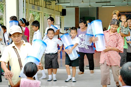 Off they go!  Happy families cart away their new water filters.