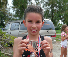 8-year old Sarah-Michelle Clear poses with her trophy after completing the Tri Kids Triathlon in Bangkok, Sunday, Sept. 15.