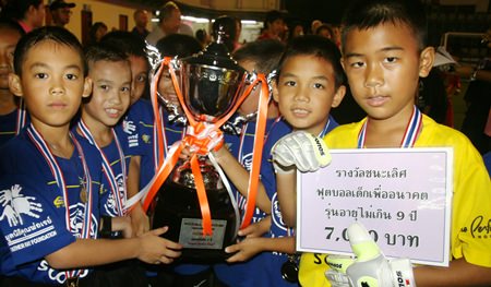 The under-9 team from Darasamuth School show off their winners’ trophy, medals and cash prize.