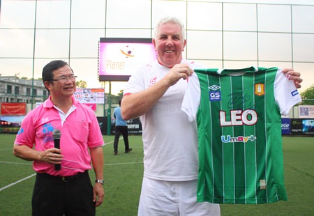 Local businessman Martin Kinsella (right) accepts the signed shirt he won in the auction from Father Michael of the Father Ray Foundation.