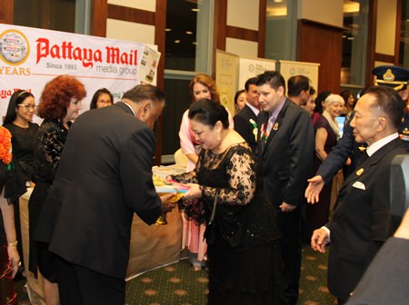 Pratheep Malhotra MD of the Pattaya Mail Media Group presents two books written by Peter Cummins commemorating the birthdays of Their Majesties the King and Queen to HRH Princess Soamwalee.