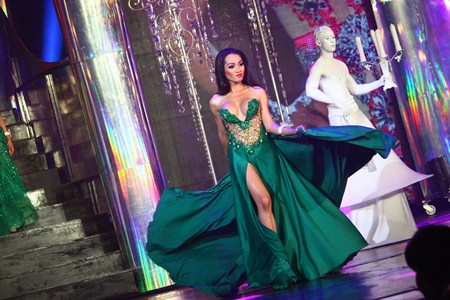 Angeline Hanum from Indonesia walks confidently in a green gown during the evening gown portion of the show.