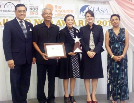 The Human Help Network Foundation accepts their award for earning 3rd Runner-Up for Thailand at the 2013 NGO Awards.