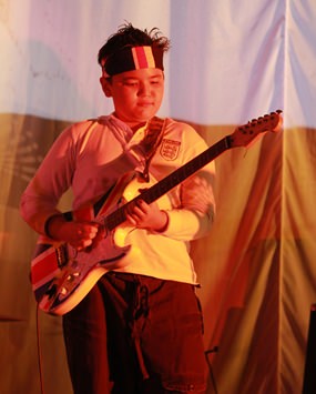 Guitar Hero! A GIS student impresses the audience at a school concert.