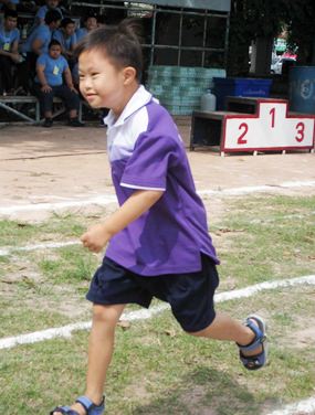 A runner in action, smiling all the way to the finish line.