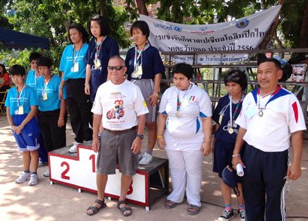 After awarding their medals, Bill poses with some of the winners and their coach.
