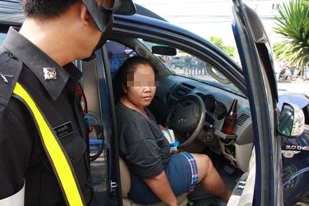 Thitipa Chaowirun, a large Singha beer still in the cup holder by the steering wheel, begins to resist arrest.
