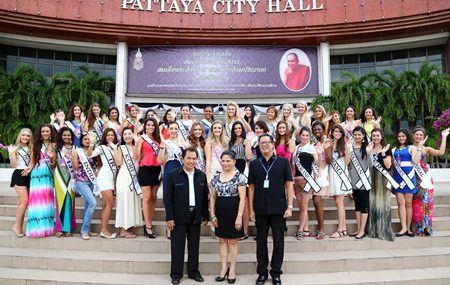 (Front row, left to right) Choosak Sriwatjanapong, City Council District 4 member, Mila Manuel, CEO and Founder of Face of Beauty International Ltd. and Pattaya Mayoral Secretary Phumipipat Kamolnat pose with the beauty contestants in front of Pattaya City Hall.