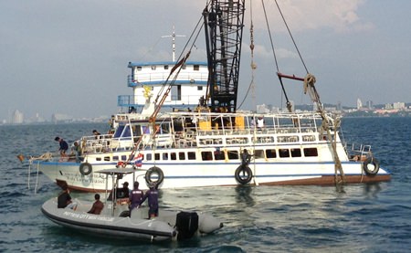 Pattaya salvage teams use slings to raise the Koh Larn Travel ferry that sunk Nov. 3, killing seven and injuring scores more.