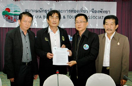 (L to R) Banglamung District Chief Sakchai Taengho and Deputy Mayor Ronakit Ekasingh, representing the government sector, accept the unsealed documents from PBTA President Sinchai Wattanasartsathorn and PBTA consultant Sa-nga Kitsamret, representing the private sector, which is insisting the government implement effective safety measures.