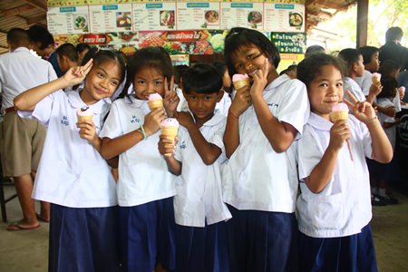 Children smile brightly whilst enjoying their favorite ice cream given to them by Hard Rock Hotel Pattaya & Hard Rock Cafe Pattaya.