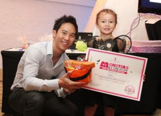 Executive Director of Royal Cliff Hotels Group, Vitanart Vathanakul, presents a certificate and special pumpkin loot bag for “Best Halloween Costume” to Tia dressed as a “pretty fairy”.