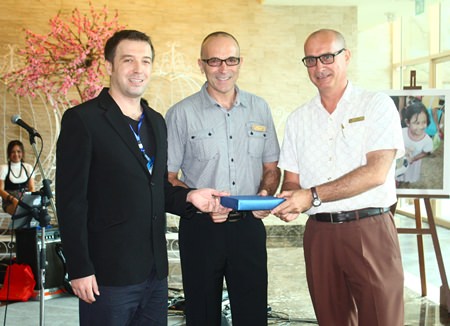 (L to R) Baki Colpam, reservation and contracting manager of Pegas, presents a souvenir to Robert John Lohrmann, general manager, and George Kenton, EAM-rooms of Centara Grand Mirage Beach Resort Pattaya as the favorite hotel chain of its Russian and Eastern European clientele.