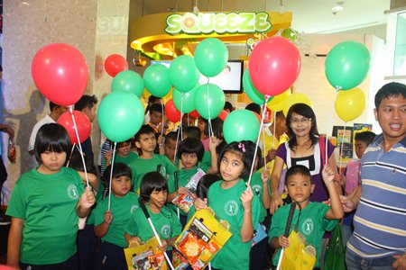 Children from the Redemptorist School for the Blind under the royal patronage of HRH Princess Maha Chakri Sirindhorn show off their colorful balloons and gifts from Santa.