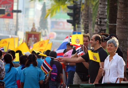 Foreign tourists get into the act, waving HM the King’s flags, celebrating Father’s Day on Pattaya Beach Road.
