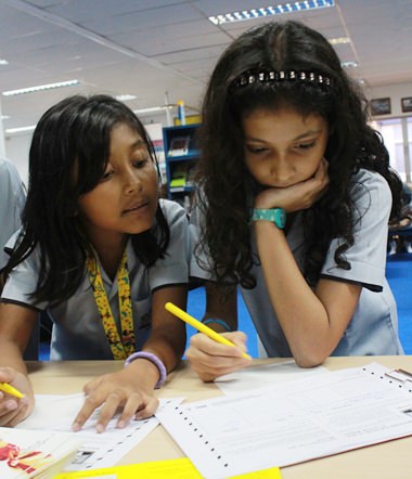 Comparing notes: GIS students compose letters for Amnesty International.