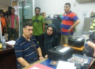 (Seated) Isa Atsan and Melaken Parsa have been arrested for grifting their countryman out of US$800.