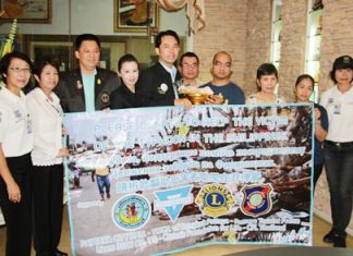 Mayor Itthiphol Kunplome (center), representing Pattaya charity groups, presents a large donation to Yu-een Khapis (4th right) from the Couples for Christ Faith Family Life, to help Philippine victims of Typhoon Haiyan.