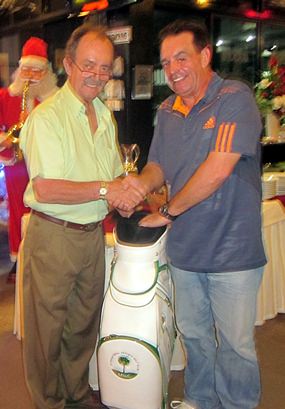 Paul Hartley (right) receives his hole in one golf bag prize from Stephen Beard.