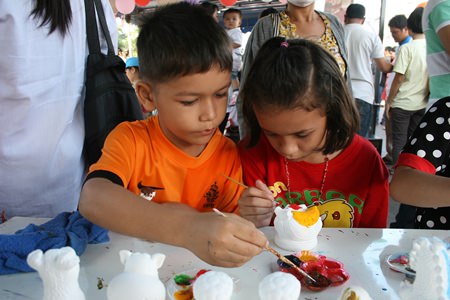 Its pure concentration as these two friends take part in a painting activity.