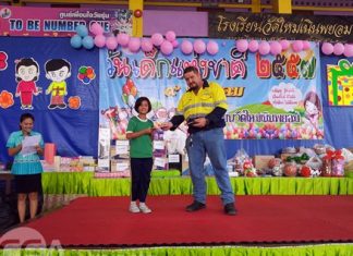 Yard Manager David Johnson hands out scholarships to the students.