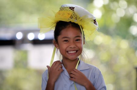 A Primary student from GIS looks great in her own special hat.