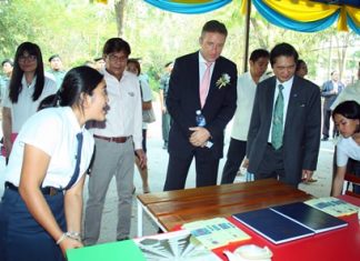 H.E. Enno Drofenik (center), Ambassador Extraordinary and Plenipotentiary of the Republic of Austria, and Watcharin Siriphanit (right), director of the Thai - Austria Technical College, listen to students presenting their inventions.