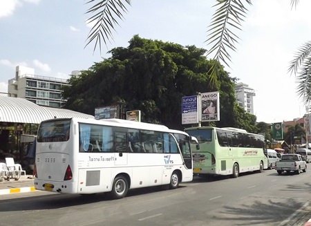 Huge tour buses are seen double parking along Beach Road.