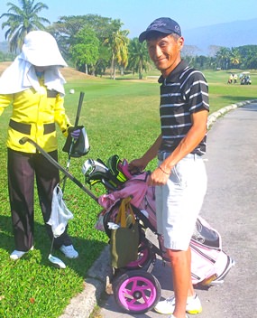 Kenny Aihara and caddy getting ready for battle.