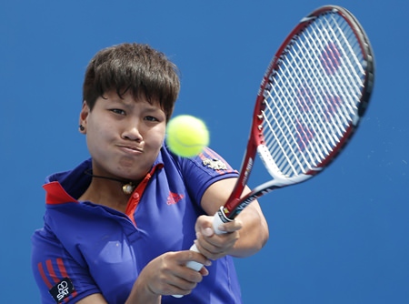 Luksika Kumkhum of Thailand makes a backhand return to Mona Barthel of Germany during their second round match at the Australian Open tennis championship, Wednesday, Jan. 15. (AP Photo/Shuji Kajiyama)