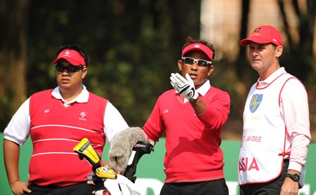 Thongchai Jaidee (center) and Kiradech Aphibarnrat (left) compete at the seventh edition of the Royal Trophy in Guangzhou, China.