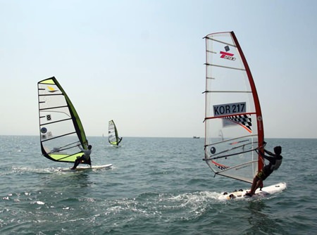 Windsurfers are seen competing during the 2014 Pattaya International Windsurfing tournament.