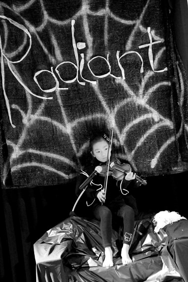 Charlotte the Spider plays her violin beautifully upon her web.