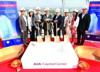 AIA executives pose for a photo on the roof of the AIA Capital Center in Bangkok during the building’s topping out ceremony.