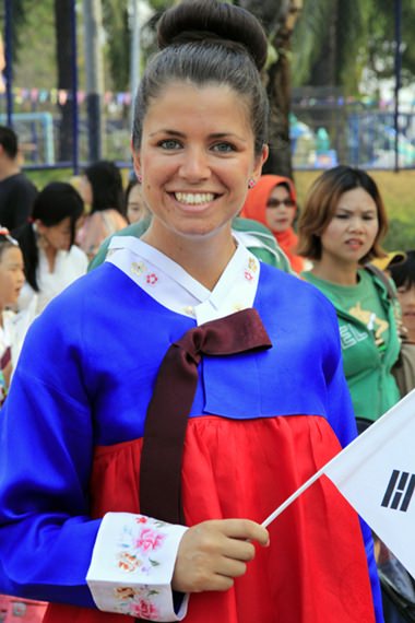 PE Teacher Samantha Howing-Nicholls joins the South Korean students for the International Day parade.