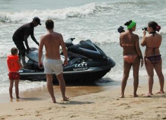 A young Russian tries to negotiate the price for alleged damage to the jet ski while his girlfriend takes photos.